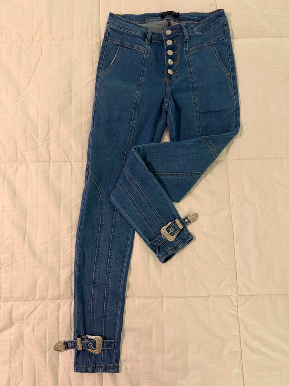 High-Rise Dark Blue Skinny Jeans with Button-Fly and Buckle Hem